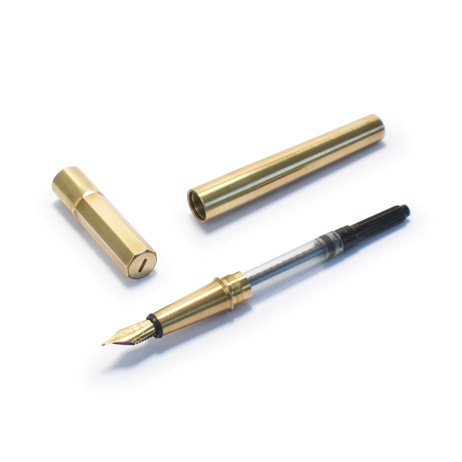 Brass fountain pen from Andhand. Shown here disassembled with various components.