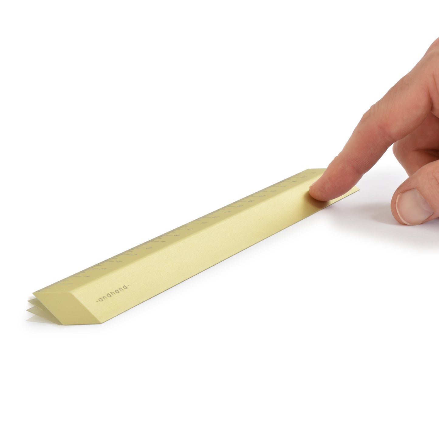 The illusion ruler by Andhand, modern and striking design. Its angled profile allows for extremely accurate mark making and measurements in both metric and imperial. Seen here in gold lustre satin anodized finish.