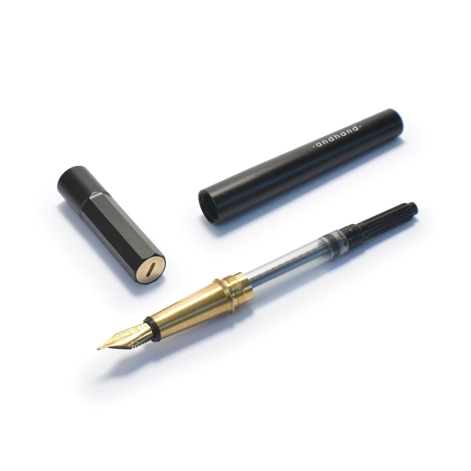 Black and brass fountain pen from Andhand. Shown here disassembled with various components.