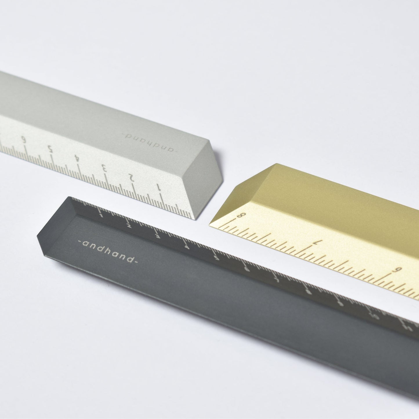 The illusion ruler by Andhand, modern and striking design. Its angled profile allows for extremely accurate mark making and measurements in both metric and imperial. Seen here in gold lustre satin anodized finish.