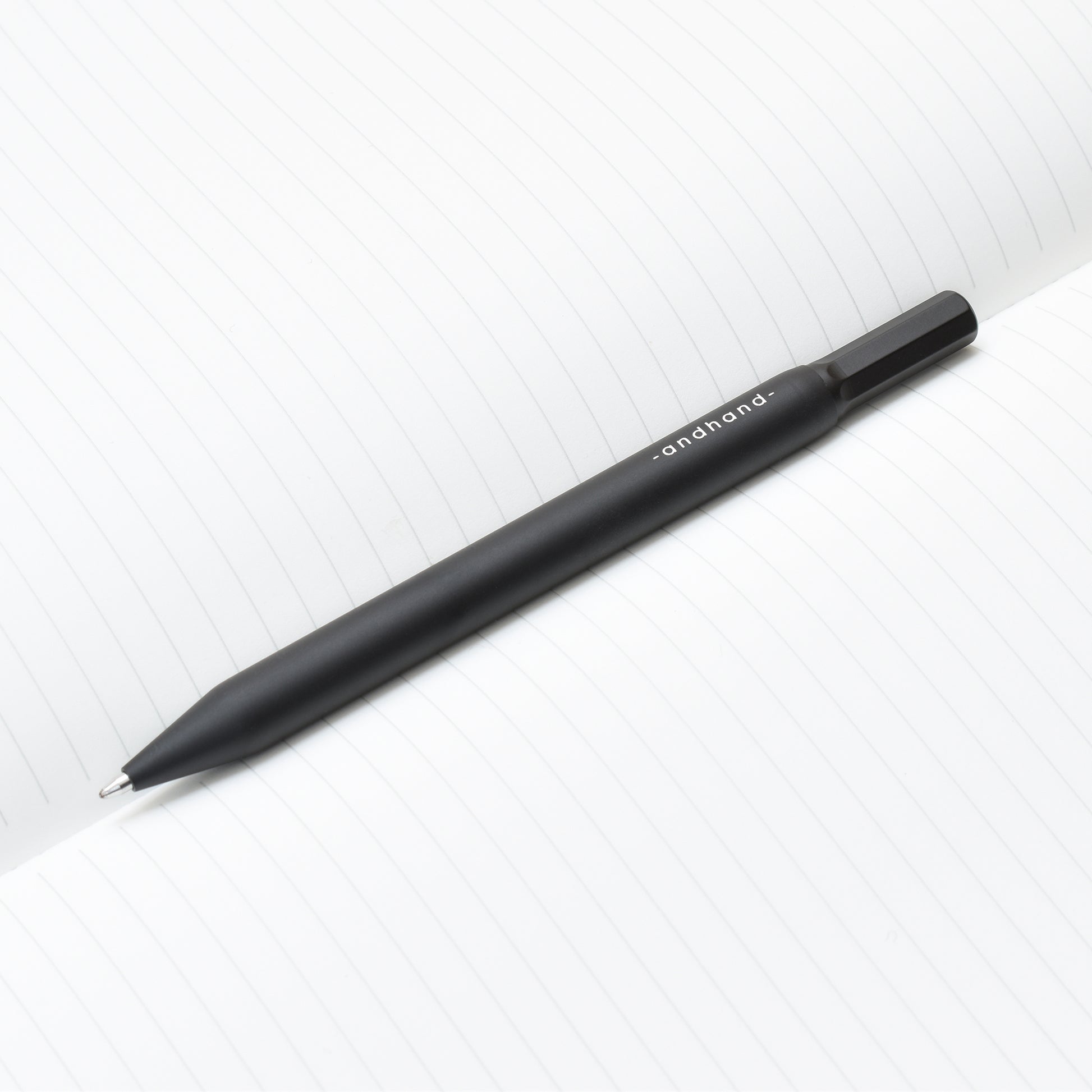 Solid aluminium & brass ballpoint black pen from Andhand. An expertly precise writing tool with a smooth mechanism and modern minimal design. Amazingly durable and refined. Shown here in black satin anodized finish.